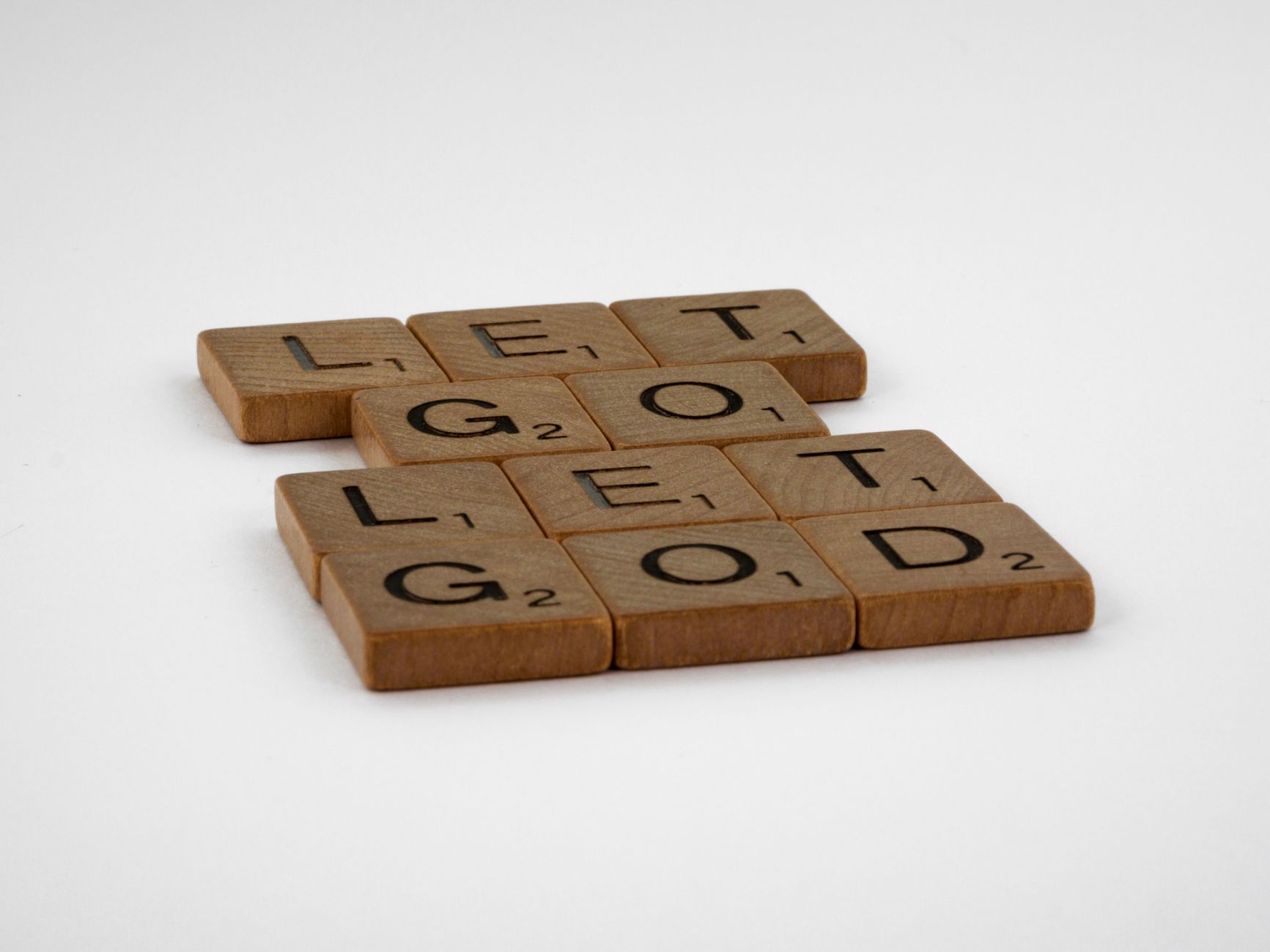 wooden scrabble tiles on white background